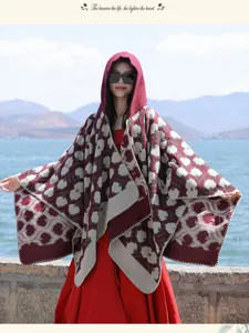 Full length shot of women's hooded travel shawl with ethnic patterns by a scenic lake
