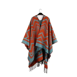 Ethnic style warm poncho shawl featuring teal and red zigzag patterns and black tassels