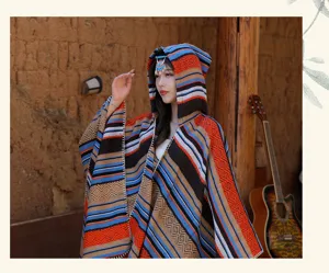 Ethnic style hooded knit poncho for women with colorful stripes and geometric patterns