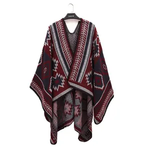 Detailed view of an ethnic knit poncho with geometric patterns in burgundy and blue