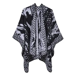 Detailed view of black and white ethnic geometric pattern knit poncho shawl wrap