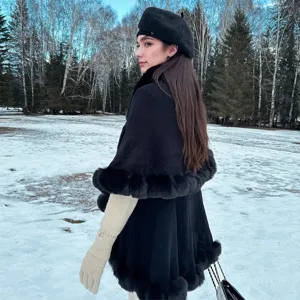 Elegant black knitted cape with faux fur collar for winter outfit