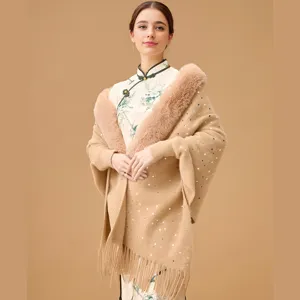 Macro detail of knit shawl featuring plush faux fur collar and delicate sequins.