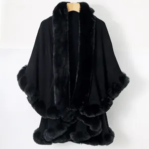 Detail view of elegant black knit cape with plush faux fur collar and trim detail.