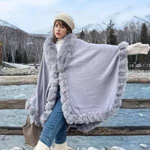 Elegant grey medium-length shawl with thick faux fur trim in a snowy outdoor scene