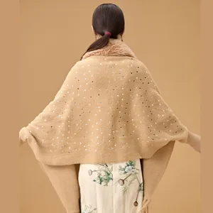 Close-up back view detail of elegant knit shawl with sequins and soft faux fur collar