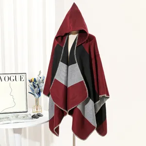 Detailed view of a stylish color-block hooded knit poncho displayed on a mannequin