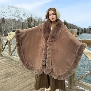 Outdoor view of a brown faux fur collar cape shawl with thick plush trim for winter.