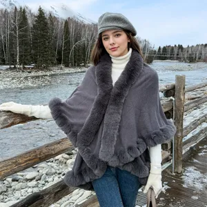 Elegant grey knit shawl with faux fur collar worn by model in winter landscape