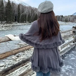 Back view of stylish double-layer grey knit poncho with fluffy faux fur trim for winter.