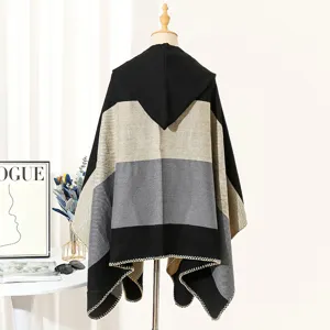 Back view of a hooded knit poncho shawl featuring a stylish color-block design.