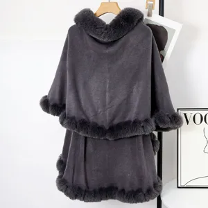 Detailed back view of dark grey knit shawl cloak with plush faux fur collar and trim