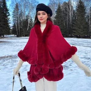 Red winter knit cape coat with thick faux fur collar and snowy forest background