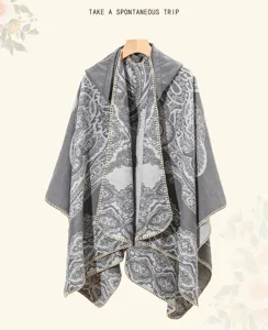 Detailansicht eines grauen Ethno-Ponchos mit Kapuze und Paisley-Muster am Bügel