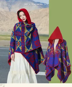 Detailed view of women's hooded ethnic print poncho against scenic mountain background