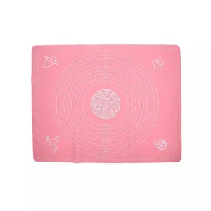 Pink silicone kneading mat with measurement scales for baking and pastry preparation.