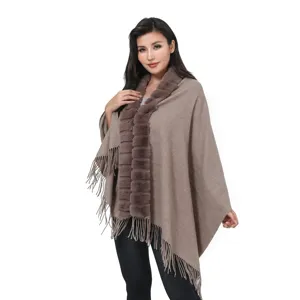 Elegant women's brown knit poncho shawl featuring a soft faux fur collar and stylish tassels