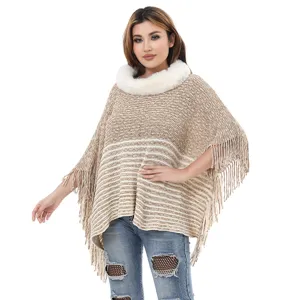 Elegant women's knitted chenille poncho with faux fur collar and tassel fringe details.