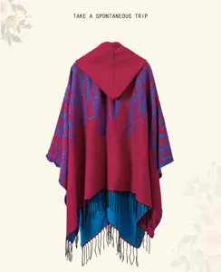 Detailed back view of a hooded ethnic style poncho in burgundy with blue feather patterns.