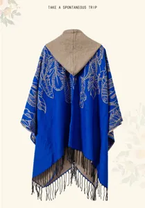 Detailed back view of an ethnic blue hooded shawl with black fringe and feather pattern