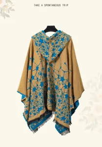 Back view of a stylish hooded knit poncho featuring blue star patterns and tassel trim