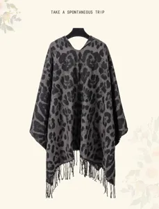 Macro view of leopard print knitted hooded poncho featuring elegant tassel fringe detail