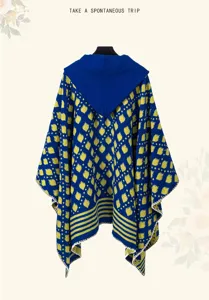Ethnic style knitted hooded poncho with blue and yellow geometric patterns for travel.