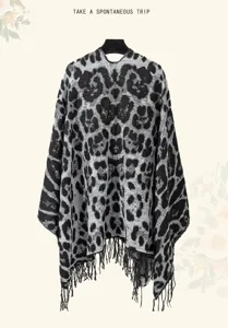 Detail of leopard print knitted shawl with fringe for bohemian travel styling