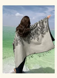 Back view of a bohemian ethnic style shawl featuring feather patterns and fringes in nature
