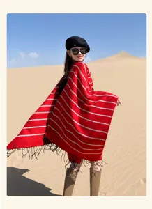 Bohemian red striped knitted shawl with tassels worn by model in desert setting