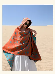 Detailed view of a fashionable women's hooded star pattern knit shawl in a desert landscape