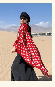 Detailed look at an ethnic red knit shawl styled for desert travel and photography.