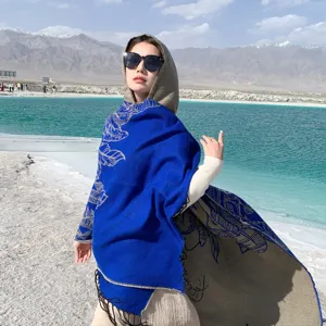 Ethnic blue hooded shawl poncho for travel and sun protection in scenic outdoors