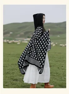 Vintage folk style knitted hooded poncho cloak with black and white geometric patterns