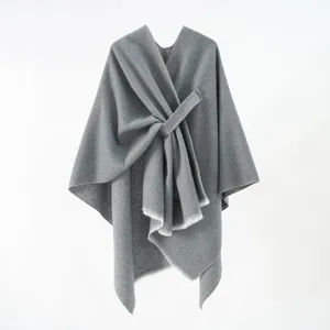Sophisticated grey knit shawl featuring a minimalist diagonal tie design and fringed edges.