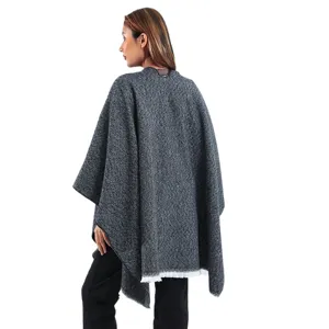 Elegant grey knit poncho cape with fringe detail back view for autumn fashion style