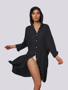 Detailed view of women's black hooded long sleeve beach cover-up shirt for summer swimwear.