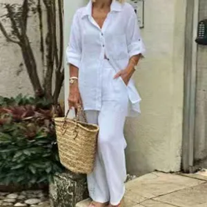 Detail view of the elegant white long-sleeve button-down shirt and pants two-piece set outfit.