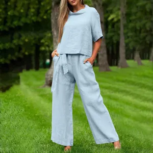 Outdoor scene detail featuring a stylish light blue casual two piece linen outfit outdoors.