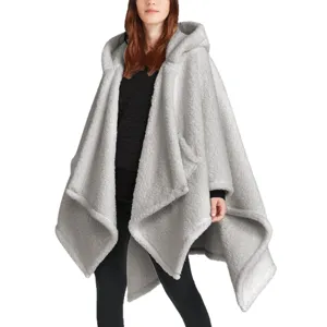 Grey fleece hooded poncho detail view, warm wearable blanket fabric texture close-up.