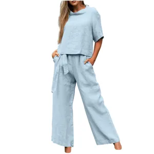 Detail shot of the light blue linen two-piece set showing relaxed fit and matching fabric.