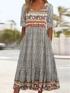 Detail shot of women's short sleeve boho floral print maxi dress featuring practical pockets.