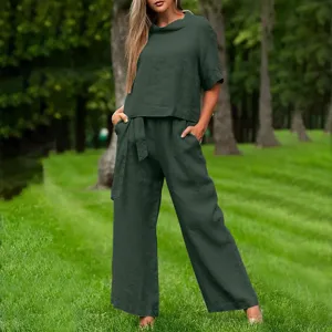 Detailed view of women's dark green short-sleeve crewneck top and wide-leg pants set.