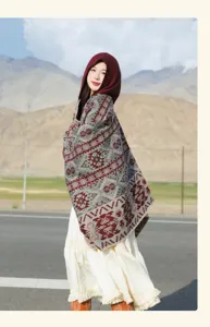 Detailed view of a vintage ethnic hooded shawl with geometric patterns on a mountain road