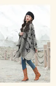 Young woman modeling a vintage geometric pattern poncho with hood in snowy mountains