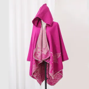 Detailed view of fuchsia hooded knitted cloak featuring elegant butterfly and floral patterns