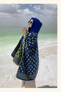 Detailed view of ethnic style hooded knitted shawl worn by a model at a salt lake scenery
