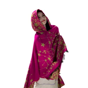 Magenta hooded knitted poncho with gold star pattern and fringe detail