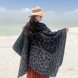Elegant leopard print knitted shawl with tassels, perfect stylish travel poncho for women.