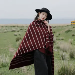 Elegant ethnic striped knitted shawl with long tassels for warm winter travel outfits